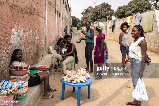 Woman gather in a street in the popular neighbourhood of Viana in Luanda on August 21, 2022. - Angolans will head to the polls on August 24, 2022 to...