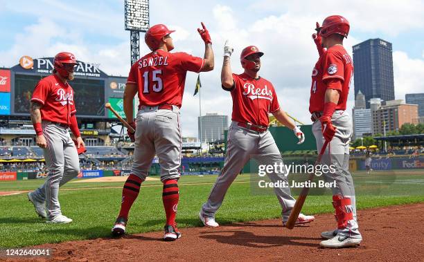 Mike Moustakas of the Cincinnati Reds celebrates with Matt Reynolds and Nick Senzel after hitting a two-run home run in the third inning during the...