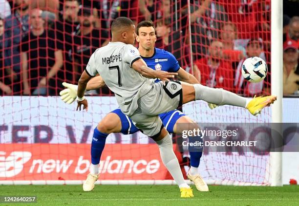 Paris Saint-Germain's French forward Kylian Mbappe scores his team's first goal during the French L1 football match between Lille OSC and Paris-Saint...