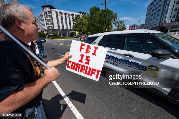 Demonstrators protest the recent actions of the FBI at their Boston headquarters in Chelsea, Massachusetts on August 21, 2022. - The protest is in...