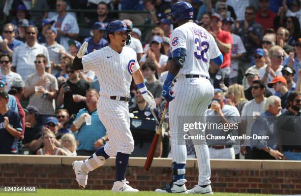 Seiya Suzuki of the Chicago Cubs is congratulated by Franmil Reyes after Suzuki hit a home run in the fourth inning against the Milwaukee Brewers at...