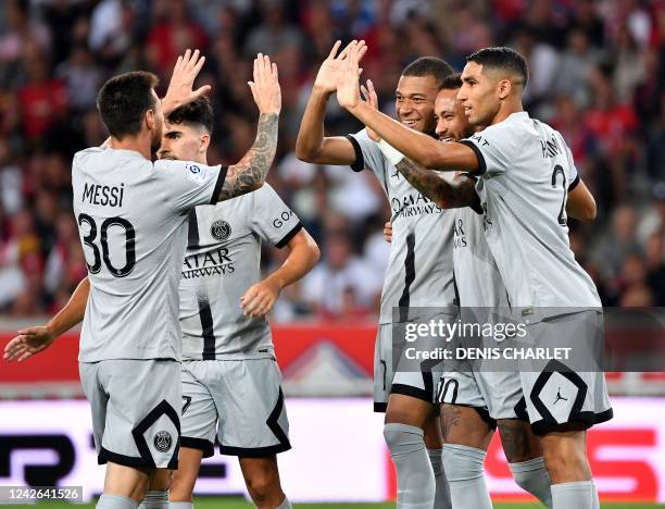 Paris Saint-Germain's Brazilian forward Neymar celebrates with teammates after scoring his team's fifth goal during the French L1 football match...