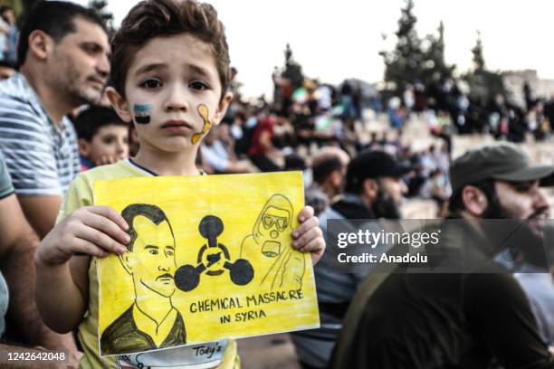 People gather to stage a demonstration against Bashar al-Assad regime's attack on Eastern Ghouta with chemical weapons on Aug. 21 in Idlib, Syria on...