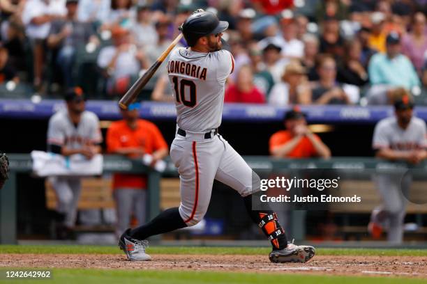 Evan Longoria of the San Francisco Giants hits a grand slam off of Kyle Freeland of the Colorado Rockies in the seventh inning at Coors Field on...