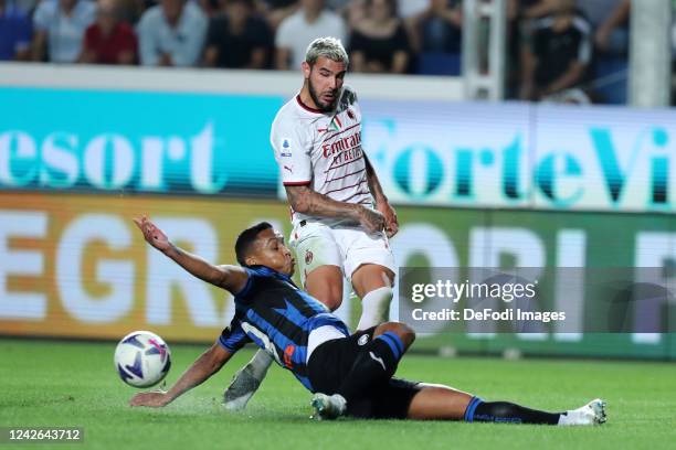 Theo Hernandez of AC Milan and Luis Muriel of Atalanta BC battle for the ball during the Serie A match between Atalanta BC and AC Milan at Gewiss...