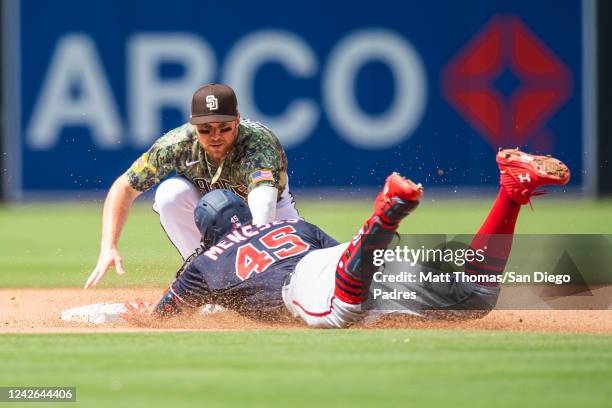 Brandon Drury of the San Diego Padres tags out a runner at second base in the sixth inning against the Washington Nationals at the PETCO Park on...