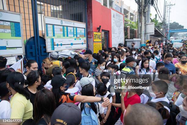 Parents drop off their children at the entrance of an elementary school in Quezon City, the Philippines, on Monday, Aug. 22, 2022. The Philippines...