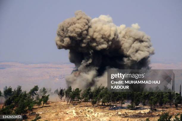Smoke billows at the site of a reported Russian strike in a forest area west of in Syria's rebel-held northwestern city of Idlib, on August 22, 2022.