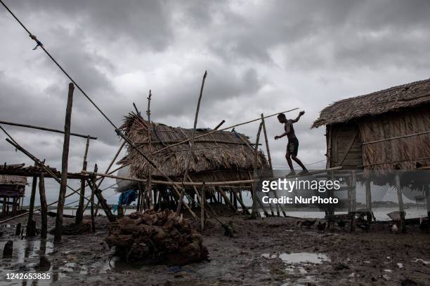 Boy seen crossing a bamboo-made bridge to go to his house at Kalabogi village in Khulna. Not too long ago Kalabogi, a coastal village in Bangladesh,...