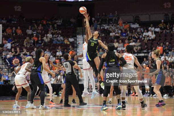 Dallas Wings forward Isabelle Harrison reaches for the ball during the tipoff against Connecticut Sun forward Jonquel Jones during Game 2 of the...
