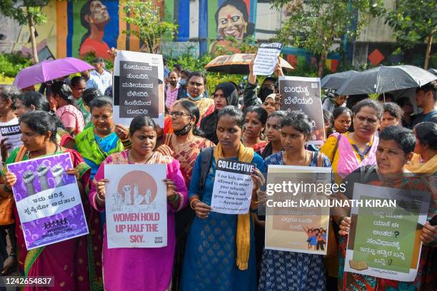 Activists hold placards during a protest against the release of men convicted of gang-raping Bilkis Bano during the 2002 communal riots in Gujarat,...