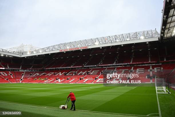 Groundsman paints the lines as final preparations are done ahead of the English Premier League football match between Manchester United and Liverpool...