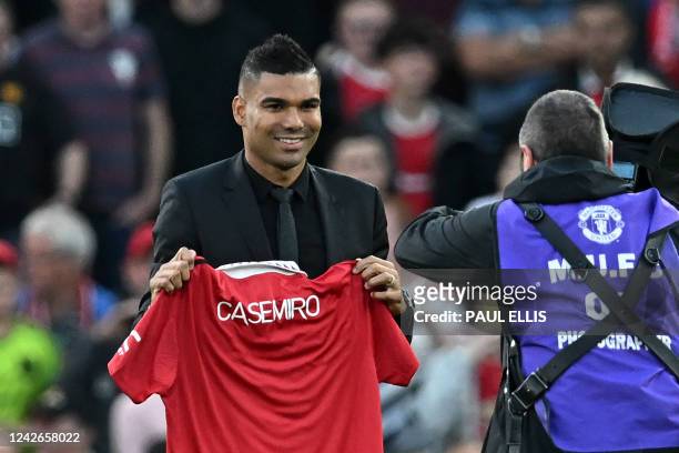 Manchester United's Brazilian midfielder Casemiro is photographed with a United shirt as he is introduced to supporters ahead of the English Premier...