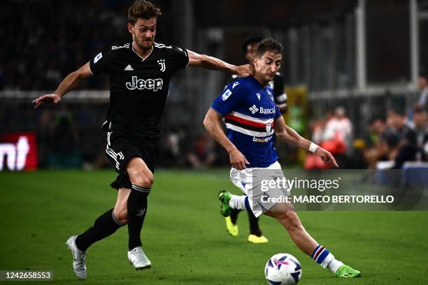 Juventus' Italian defender Daniele Rugani fights for the ball with Sampdoria's Serbian midfielder Filip Djuricic during the Italian Serie A football...