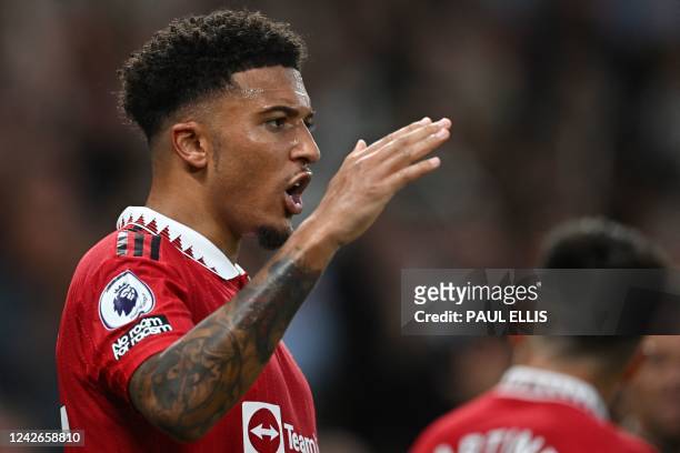 Manchester United's English striker Jadon Sancho celebrates after scoring the opening goal during the English Premier League football match between...