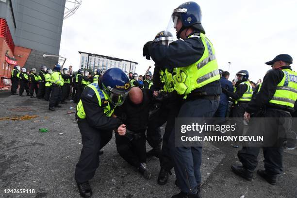 Protesters clash with police as they gather outside Old Trafford stadium to demonstrate against Manchester United's owners ahead of the English...