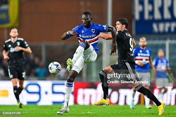 Omar Colley of Sampdoria and Dusan Vlahovic of Juventus vie for the ball during the Serie A match between UC Sampdoria and Juventus at Stadio Luigi...