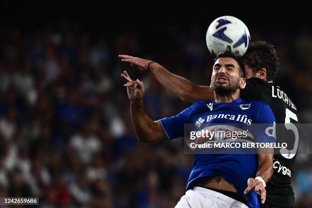 Sampdoria's French forward Mehdi Leris jumps for the ball with Juventus' Italian midfielder Manuel Locatelli during the Italian Serie A football...