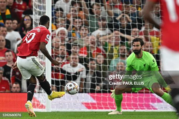 Manchester United's English striker Marcus Rashford shoots past Liverpool's Brazilian goalkeeper Alisson Becker to score their second goal during the...