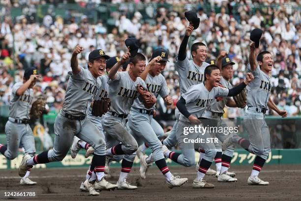 This photo taken on August 22, 2022 shows members of Sendai Ikuei, a school in Miyagi prefecture, running over to the school's cheering section in...