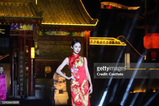 Model wears a cheongsam as she walks on the runway in Shenyang, Liaoning province, China, Aug 22, 2022.