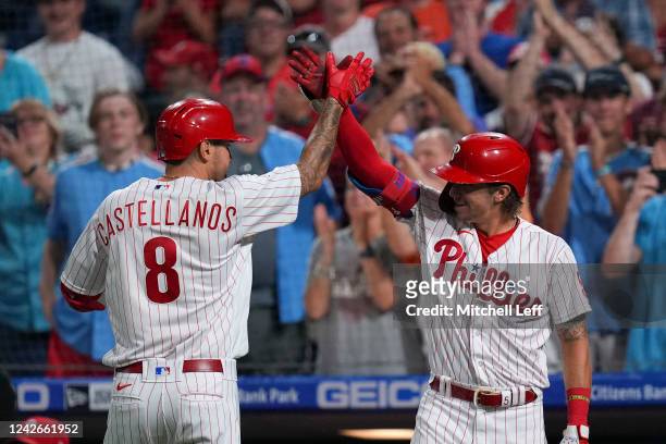 Nick Castellanos of the Philadelphia Phillies high fives Bryson Stott after hitting a solo home run in the bottom of the second inning against the...