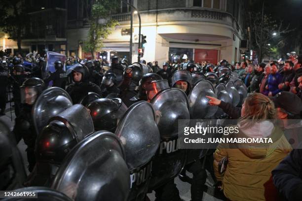 Riot police separate supporters and detractors of Argentina's Vice-President Cristina Fernandez de Kirchner demonstrating outside her apartment in...