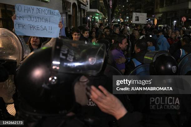 Riot police try to disperse people demonstrating against Argentina's Vice-President Cristina Fernandez de Kirchner as they separate them from her...