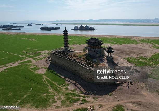 An aerial picture taken on August 23, 2022 shows the usually half submerged in water Luoxing Dun, a small island with ancient temples on it, in...
