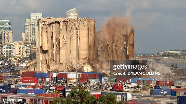 This grab from AFPTV footage shot on August 23, 2022 shows the collapse of the northern section of the grain silos at the port of Lebanon's capital...