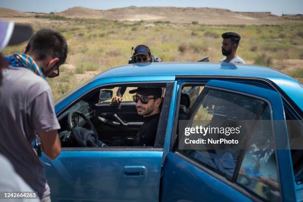 Iranian driver and a member of the Fast Forward Team, Datis Mirshokraei , talks to a member of a filming group as he sits in a Hyundai excel...