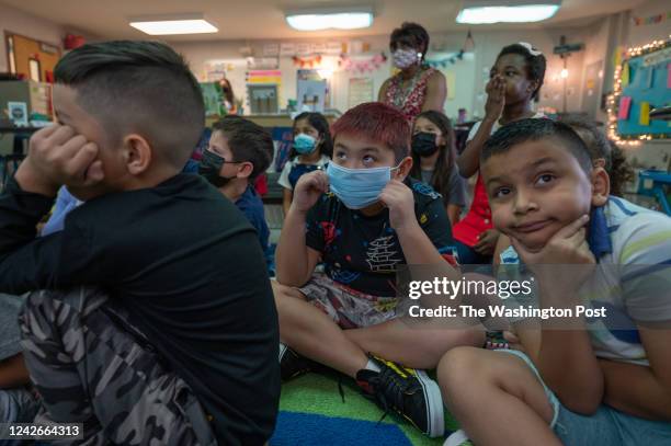 Third grader Nathan Khong fiddles with his face mask in Erin Crisss class at Forestdale Elementary School in Springfield, VA on August 22, 2022.