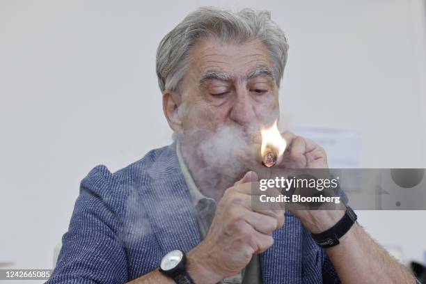 Nick Hayek, chief executive officer of Swatch Group AG, lights a cigar during an interview at the company's headquarters in Biel, Switzerland, on...