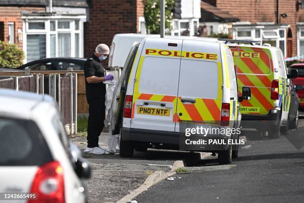 Member of the British Police scientific support unit gets ready to inspect a house in the Knotty Ash area in Liverpool on August 23, 2022 after a...