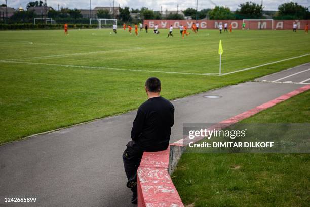 Mariupol's president Oleksandr Yaroshenko watches his team warming-up match against FC Nyva at a tiny Demydiv village stadium 20 kilometres north of...