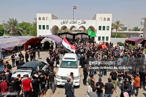 Supporters of Iraqi Muslim Shiite cleric Moqtada Sadr gather outside the headquarters of the Supreme Judicial Council, Iraq's highest judicial body,...