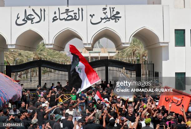 Supporters of Iraqi Muslim Shiite cleric Moqtada Sadr gather outside the headquarters of the Supreme Judicial Council, Iraq's highest judicial body,...
