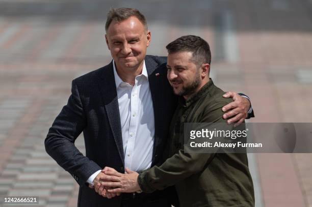 Polish President Andrzej Duda and Ukrainian President Volodymyr Zelensky shake hands and hug during their press conference on August 23, 2022 in...