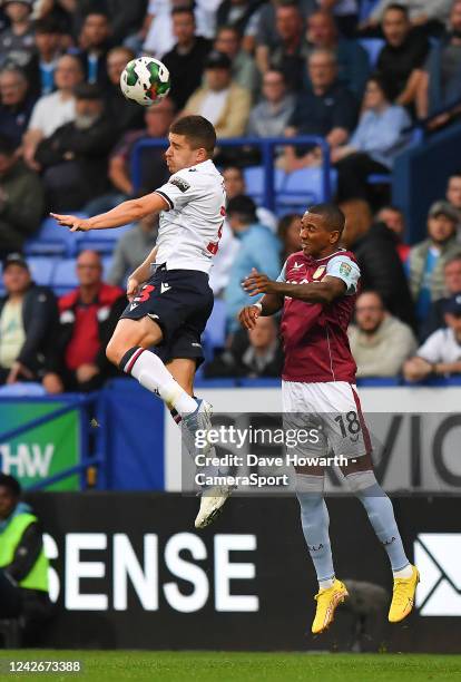 Bolton Wanderers' Declan John battles with Aston Villa's Ashley Young during the Carabao Cup Second Round match between Bolton Wanderers and Aston...