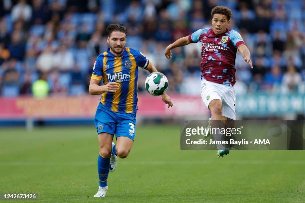 Luke Leahy of Shrewsbury Town and Manuel Benson of Burnley during the Carabao Cup Second Round match between Shrewsbury Town and Burnley at New...