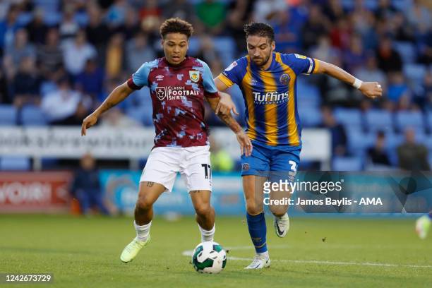 Manuel Benson of Burnley and Luke Leahy of Shrewsbury Town during the Carabao Cup Second Round match between Shrewsbury Town and Burnley at New...