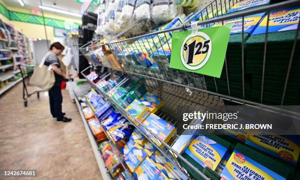 Woman shops at a Dollar Store in ALhambra, California on August 23, 2022. - US shoppers are facing increasingly high prices on everyday goods and...