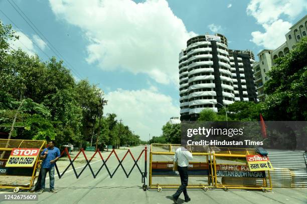 Security personnel puts barricades outside Supertech Twin Tower at sector 93, ahead of its demolition on August 28 on August 23, 2022 in Noida,...