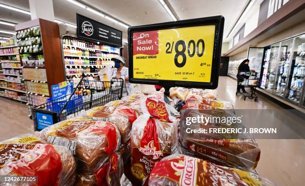 People shop at a supermarket in Montebello, California, on August 23, 2022. - US shoppers are facing increasingly high prices on everyday goods and...