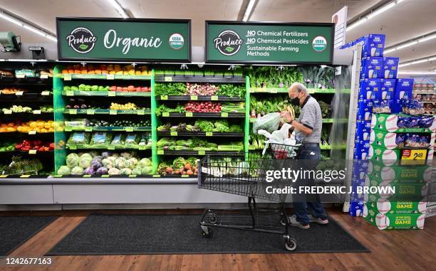 Shopper looks at organic produce at a supermarket in Montebello, California, on August 23, 2022. - US shoppers are facing increasingly high prices on...