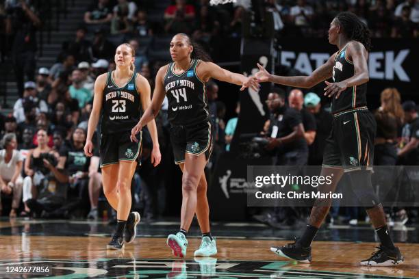 Betnijah Laney high fives Natasha Howard of the New York Liberty during Round 1 Game 3 of the 2022 WNBA Playoffs on August 23, 2022 at the Barclays...