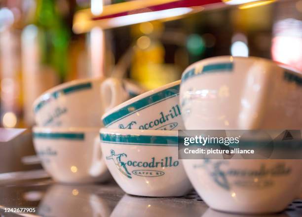 August 2022, Berlin: Cups with "Coccodrillo" printed on them stand on a coffee machine in the dining room at the "Coccodrillo" restaurant in...