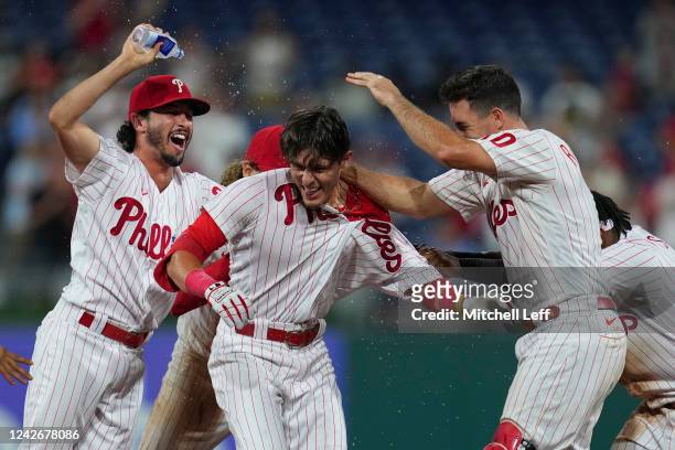 Nick Maton of the Philadelphia Phillies celebrates with Garrett Stubbs, Alec Bohm, Jean Segura and J.T. Realmuto after hitting the game-winning RBI...