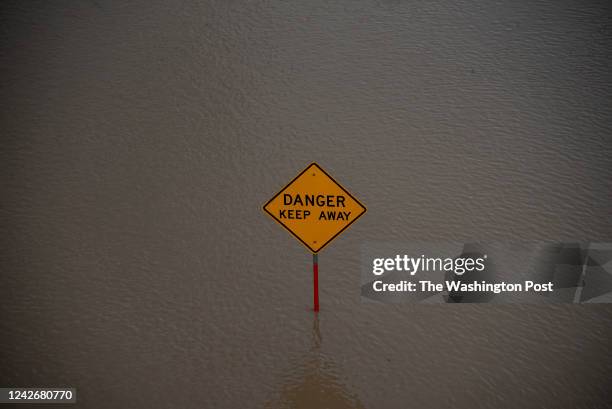 Sign is visible in a flooded area of The Trinity River in Dallas, Texas on Monday, August 22, 2022.