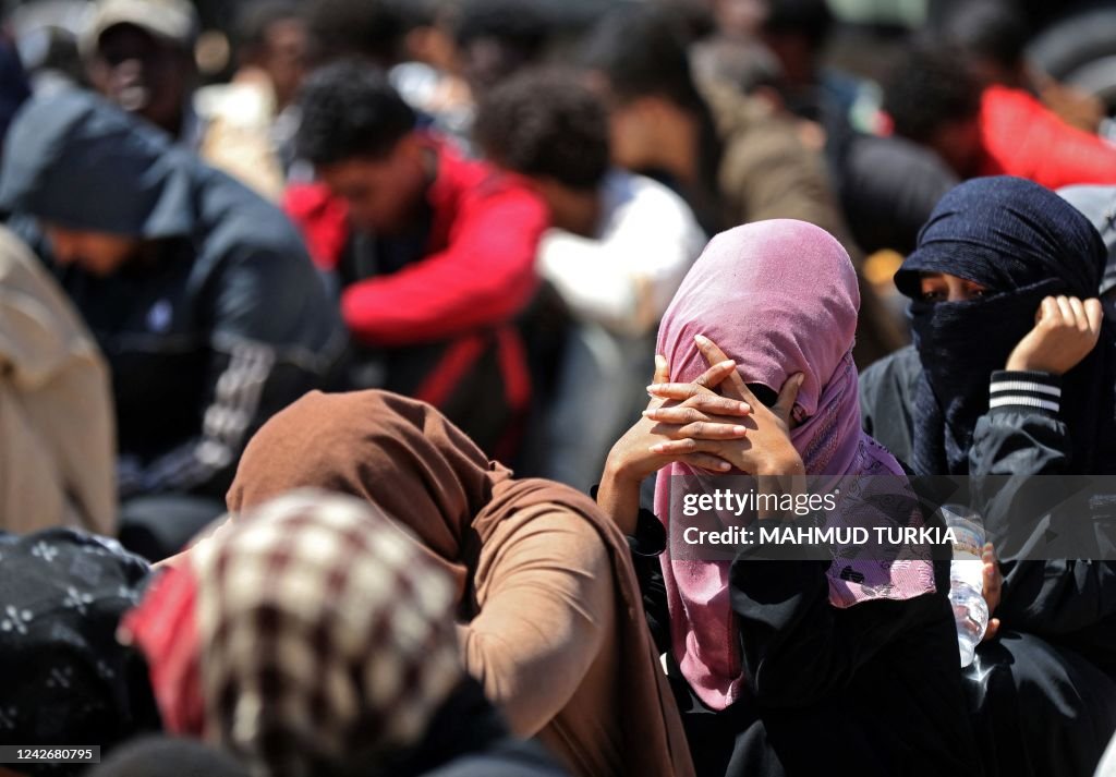 Migrants who were detained by Libyan authorities on a boat off the ...